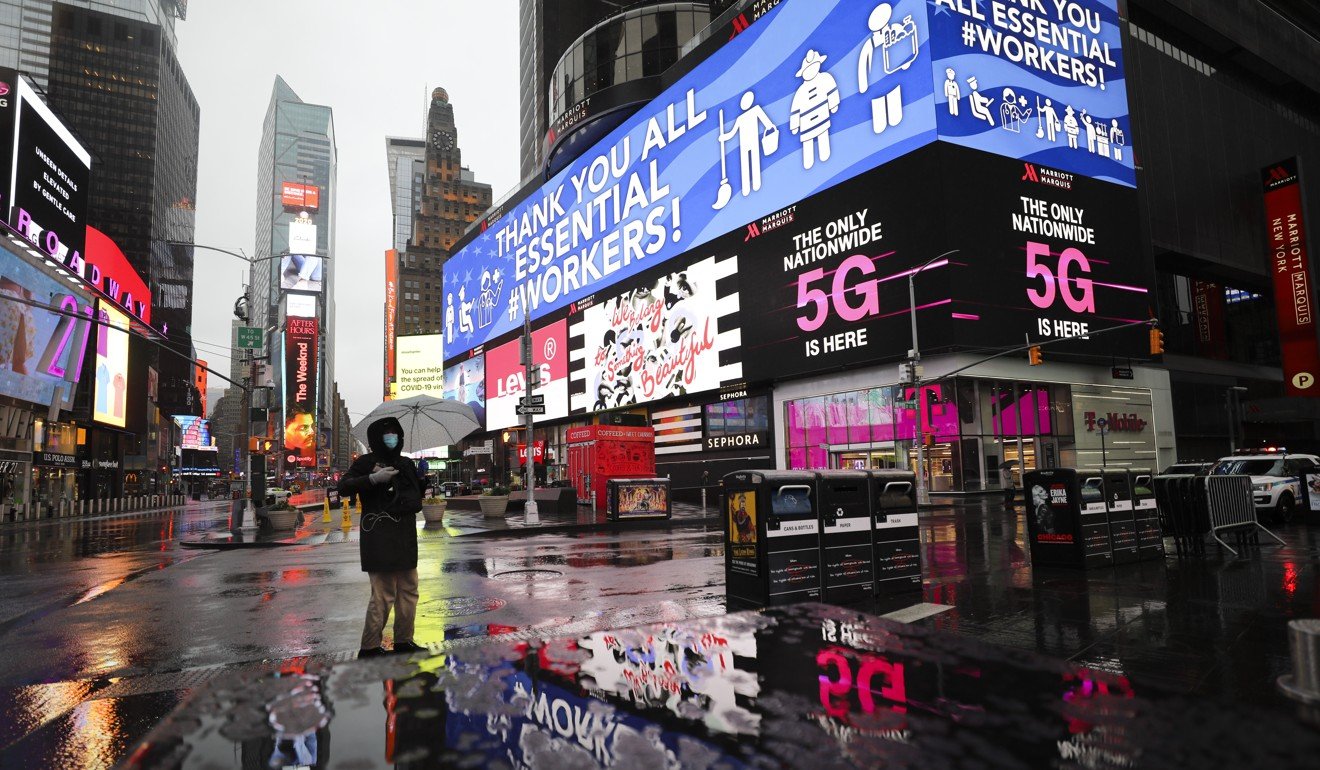 A person stands in a deserted Times Square in New York on March 23. The city has recorded more than 20,000 cases. Photo: Xinhua